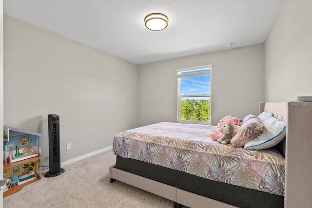 bedroom featuring carpet and baseboards
