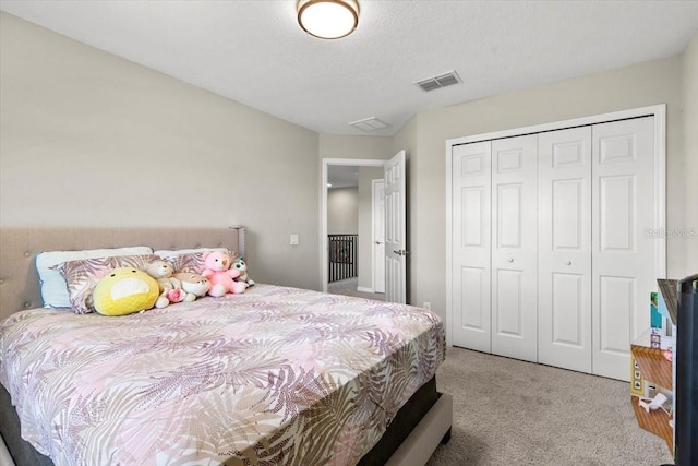 bedroom featuring carpet, visible vents, and a closet