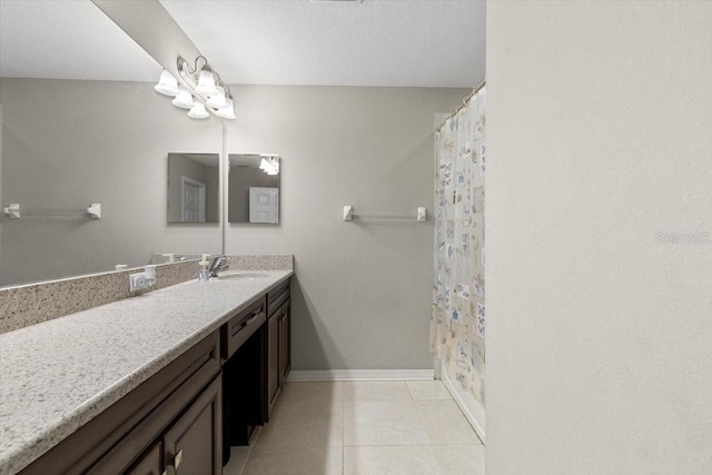 full bathroom with tile patterned floors, a shower with shower curtain, vanity, and baseboards