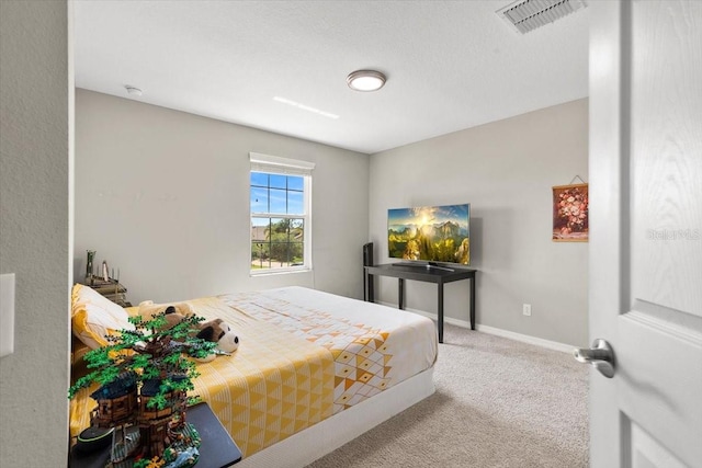 bedroom with visible vents, baseboards, and carpet