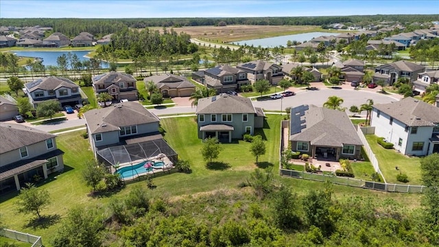 drone / aerial view featuring a water view and a residential view