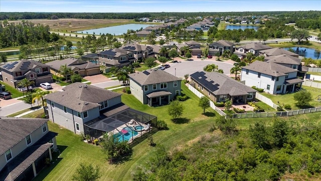 birds eye view of property with a water view and a residential view