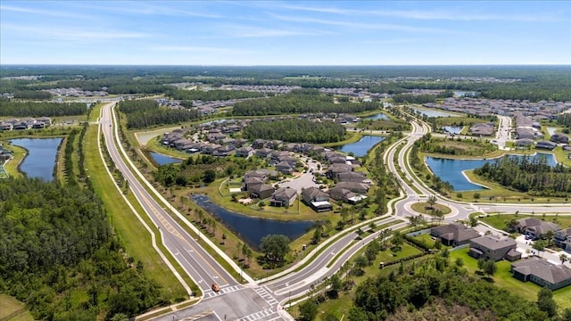 drone / aerial view with a water view and a residential view