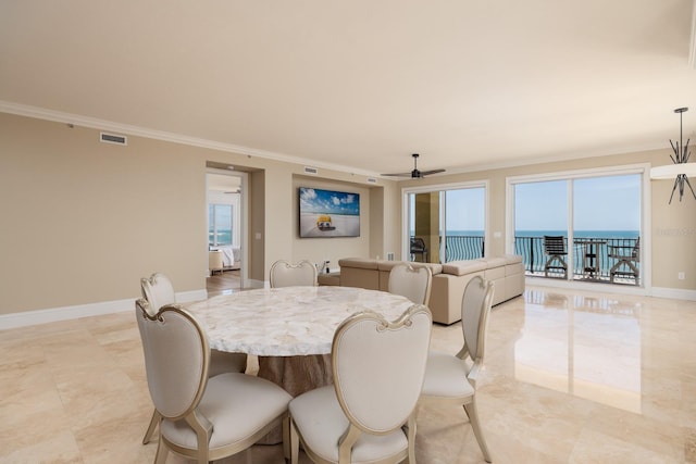 dining space with ornamental molding, visible vents, baseboards, and a ceiling fan