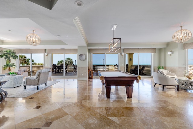 game room featuring pool table, an inviting chandelier, crown molding, and a raised ceiling