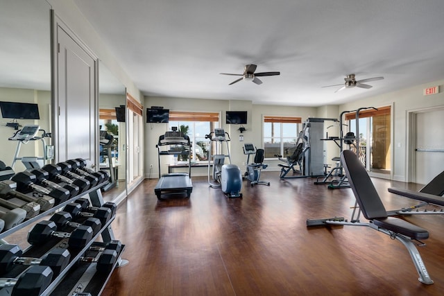 workout area with wood finished floors, ceiling fan, and baseboards