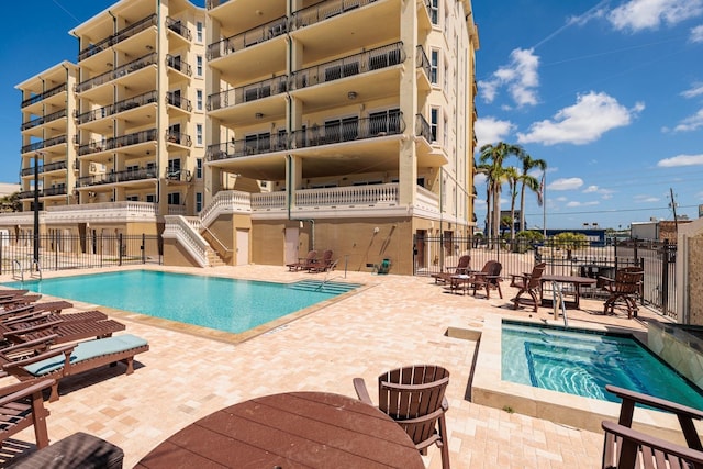 pool featuring a patio area and fence