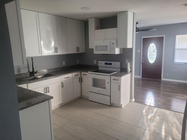 1615 Stevensons Dr, Clearwater, FL 33755 - kitchen with white appliances, a sink, white cabinetry, and a ceiling fan