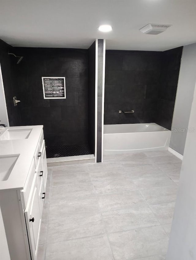 1615 Stevensons Dr, Clearwater, FL 33755 - full bath with tiled shower, a garden tub, double vanity, tile patterned flooring, and baseboards