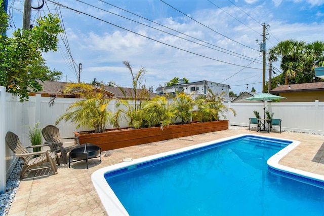 3066 Highland St N, Saint Petersburg, FL 33704 - view of swimming pool featuring a fire pit, a patio, and a fenced backyard