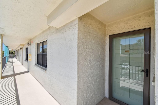 entrance to property featuring stucco siding