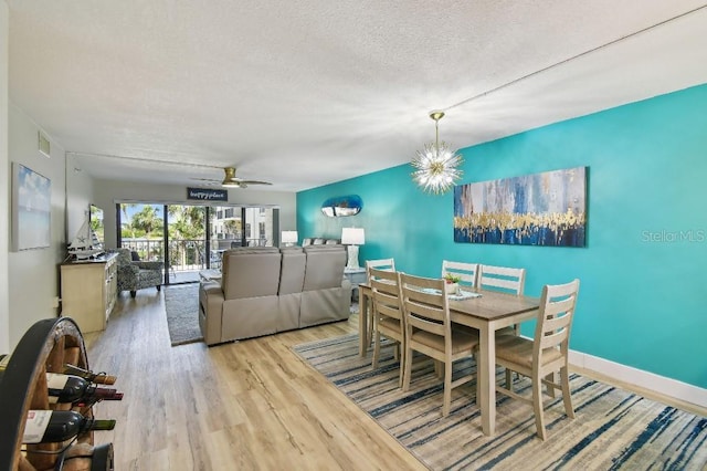 dining area with visible vents, baseboards, ceiling fan, a textured ceiling, and wood finished floors