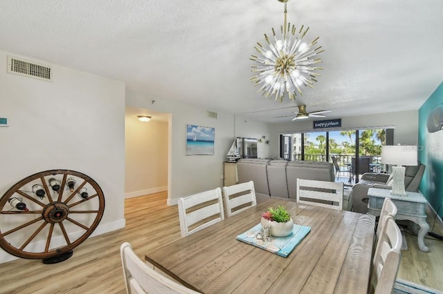 dining area with wood finished floors, baseboards, and visible vents