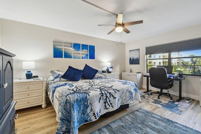 bedroom with baseboards, light wood-type flooring, and ceiling fan