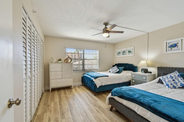 bedroom featuring baseboards, a ceiling fan, and wood finished floors