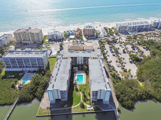 bird's eye view with a water view, a city view, and a view of the beach