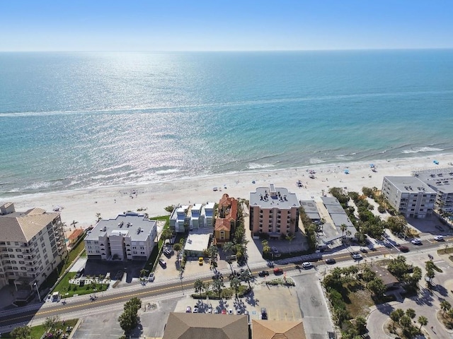 drone / aerial view featuring a water view and a beach view