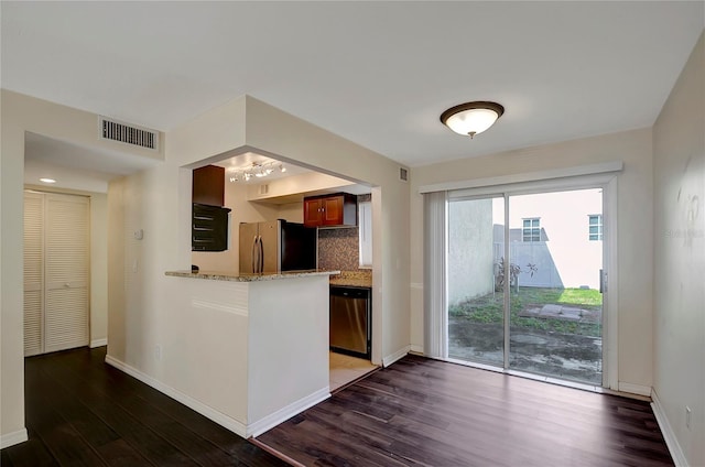 3206 W Azeele St Unit 126, Tampa, FL 33609 - kitchen with stainless steel appliances, dark wood finished floors, tasteful backsplash, baseboards, and light stone countertops