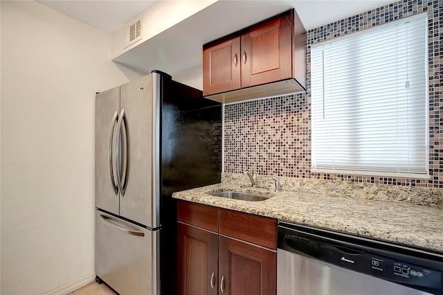 3206 W Azeele St Unit 126, Tampa, FL 33609 - kitchen featuring appliances with stainless steel finishes, a sink, light stone countertops, tasteful backsplash, and baseboards