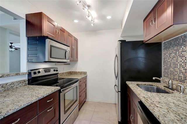 3206 W Azeele St Unit 126, Tampa, FL 33609 - kitchen featuring stainless steel appliances, light stone countertops, light tile patterned floors, a sink, and baseboards