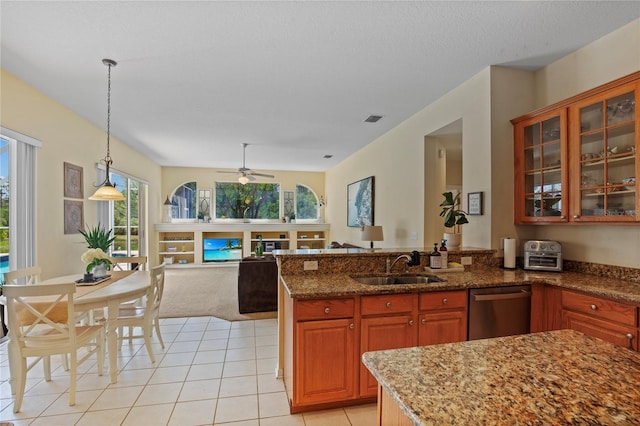 kitchen featuring open floor plan, decorative light fixtures, a sink, visible vents, and dishwasher