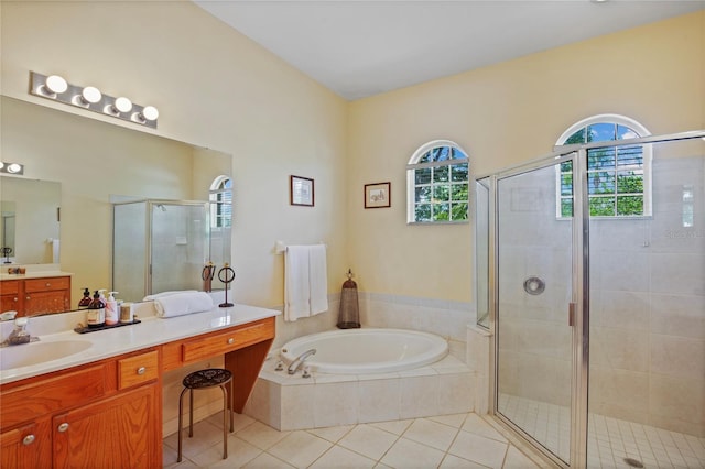 bathroom with a shower stall, vanity, tile patterned flooring, and a bath