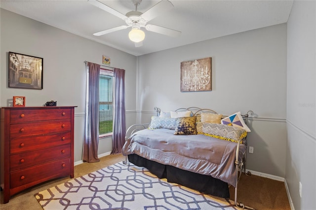 bedroom featuring baseboards, light colored carpet, and ceiling fan