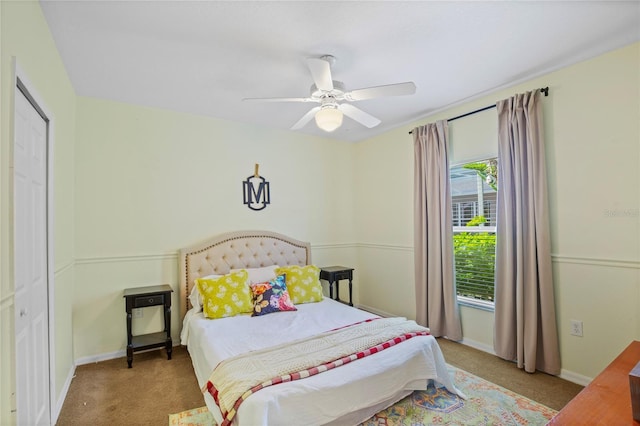 carpeted bedroom featuring baseboards and ceiling fan