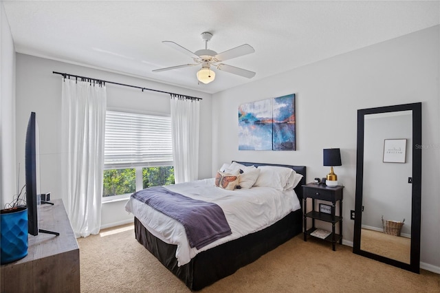 carpeted bedroom with baseboards and ceiling fan