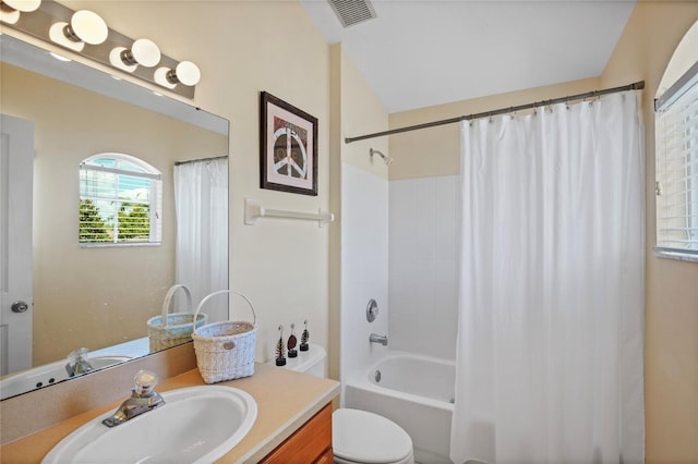 bathroom with toilet, vanity, shower / tub combo with curtain, and visible vents
