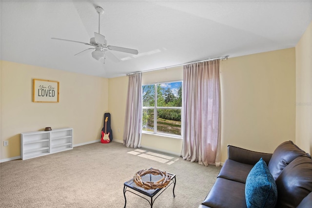 living area featuring carpet flooring, a ceiling fan, and baseboards