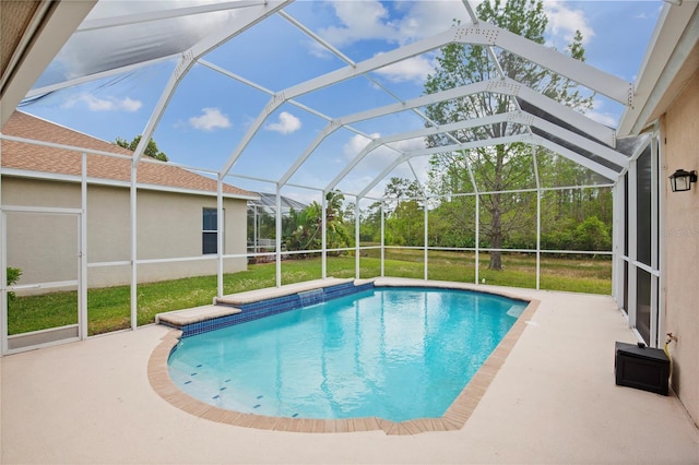 outdoor pool featuring a patio, a yard, and glass enclosure