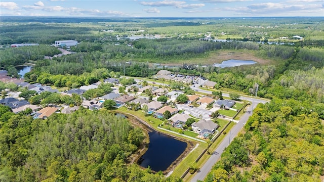 aerial view featuring a residential view, a water view, and a view of trees