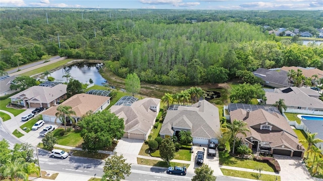 aerial view with a residential view, a water view, and a view of trees