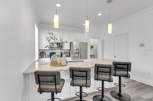 2410 W N A St Unit 2, Tampa, FL 33609 - kitchen with stainless steel fridge with ice dispenser, decorative backsplash, a kitchen bar, and crown molding