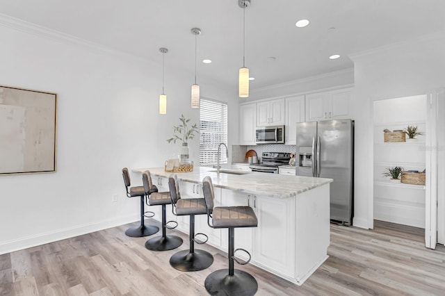 2410 W N A St Unit 2, Tampa, FL 33609 - kitchen featuring tasteful backsplash, a peninsula, ornamental molding, appliances with stainless steel finishes, and a sink