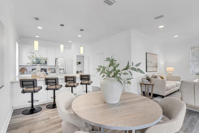 2410 W N A St Unit 2, Tampa, FL 33609 - dining room with crown molding, light wood finished floors, visible vents, and recessed lighting