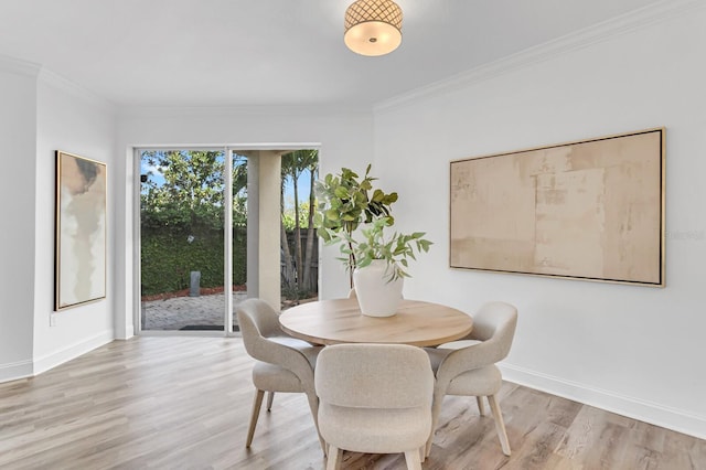 2410 W N A St Unit 2, Tampa, FL 33609 - dining area with light wood-style flooring, baseboards, and ornamental molding