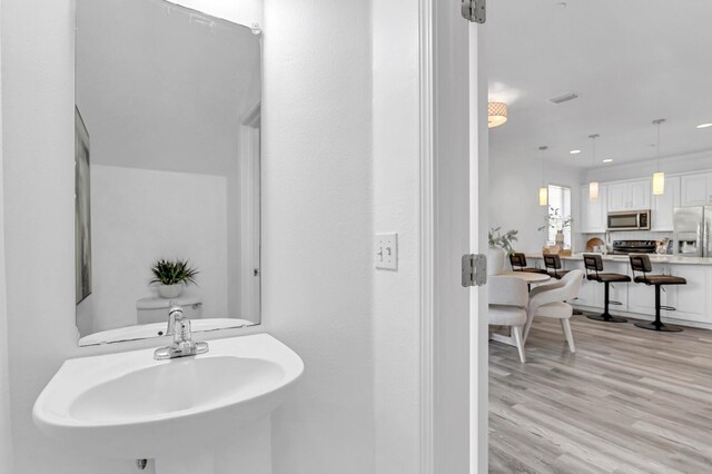 2410 W N A St Unit 2, Tampa, FL 33609 - bathroom with a sink, visible vents, recessed lighting, and wood finished floors