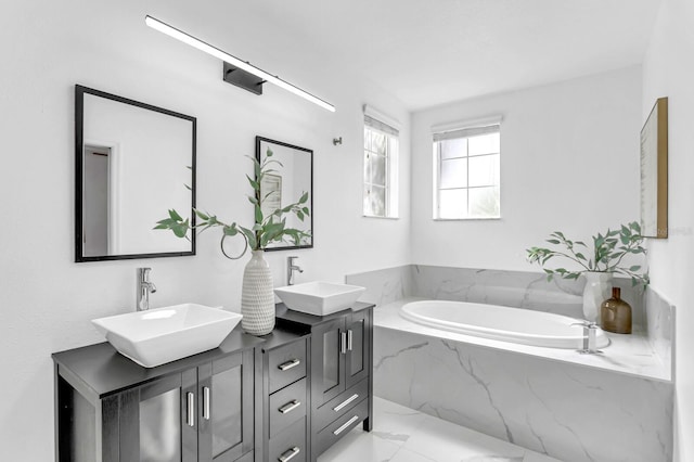 2410 W N A St Unit 2, Tampa, FL 33609 - bathroom featuring marble finish floor, a bath, double vanity, and a sink