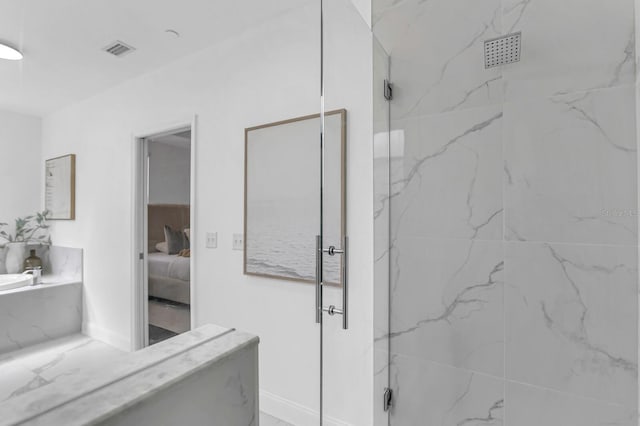 2410 W N A St Unit 2, Tampa, FL 33609 - ensuite bathroom with a marble finish shower, baseboards, visible vents, and connected bathroom