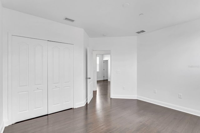 2410 W N A St Unit 2, Tampa, FL 33609 - unfurnished bedroom featuring dark wood-type flooring, visible vents, baseboards, and a closet
