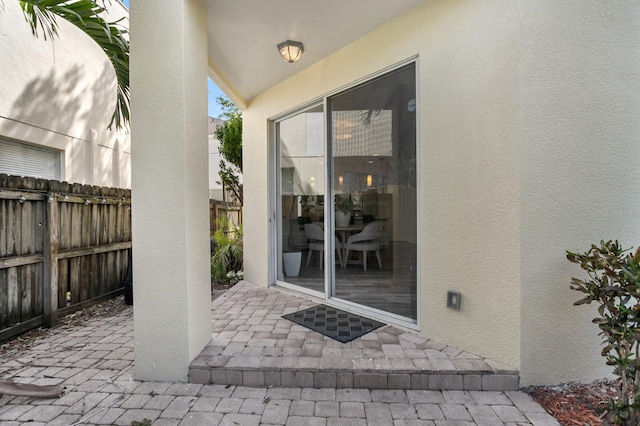 2410 W N A St Unit 2, Tampa, FL 33609 - doorway to property with a patio area, stucco siding, and fence