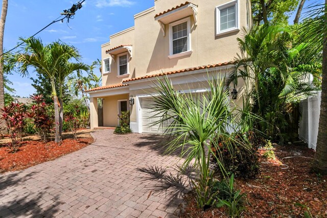 2410 W N A St Unit 2, Tampa, FL 33609 - mediterranean / spanish house featuring a garage, stucco siding, a tile roof, and decorative driveway