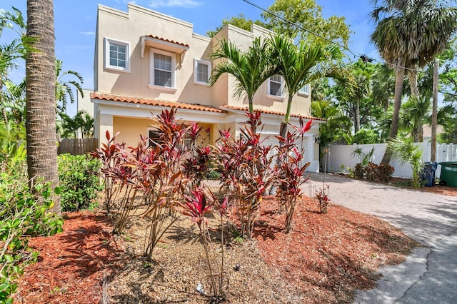 2410 W N A St Unit 2, Tampa, FL 33609 - view of front of property with driveway, stucco siding, a tiled roof, and fence