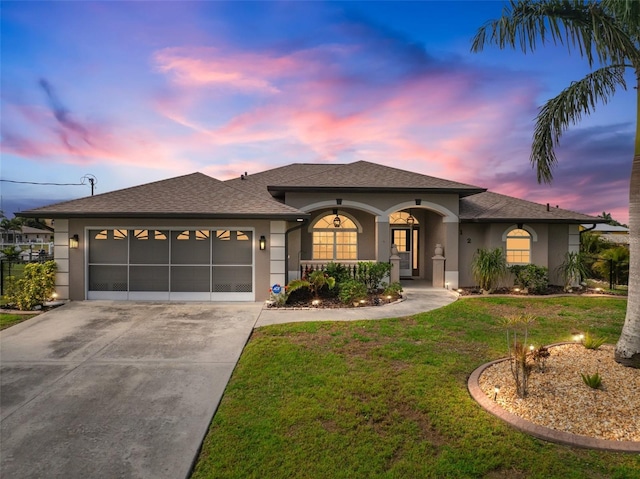 121 Colonial St SW, Port Charlotte, FL 33952 - view of front of property with stucco siding, an attached garage, driveway, covered porch, and a yard