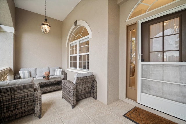 121 Colonial St SW, Port Charlotte, FL 33952 - doorway to property featuring stucco siding, an outdoor hangout area, and a patio
