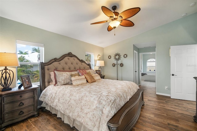 121 Colonial St SW, Port Charlotte, FL 33952 - bedroom featuring vaulted ceiling, dark wood-style flooring, baseboards, ensuite bath, and a ceiling fan