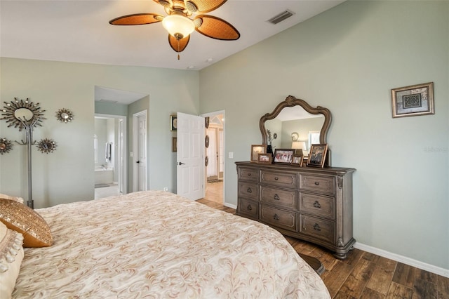 121 Colonial St SW, Port Charlotte, FL 33952 - bedroom with visible vents, baseboards, ensuite bath, dark wood-style floors, and vaulted ceiling