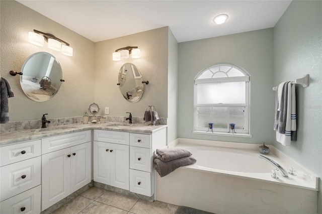 121 Colonial St SW, Port Charlotte, FL 33952 - full bath featuring double vanity, a sink, a garden tub, and tile patterned flooring
